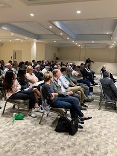 A theatre style event with people sat in chairs in the Wolfson Hall space at The Central.
